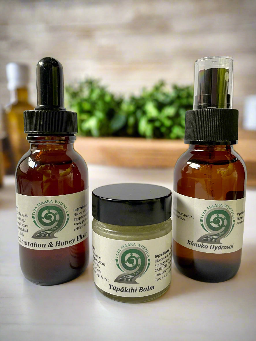 Three Tuia Maara Whenua Rongoa products including a Kānuka Hydrosol spray bottle, a Kāmarahou & Honey Elixir dropper bottle, and a Tāpākihi Balm jar.